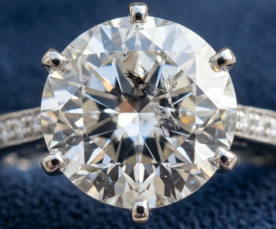 Diamond Inclusions Bruised, But Not Broken displayed up close on a diamond ring